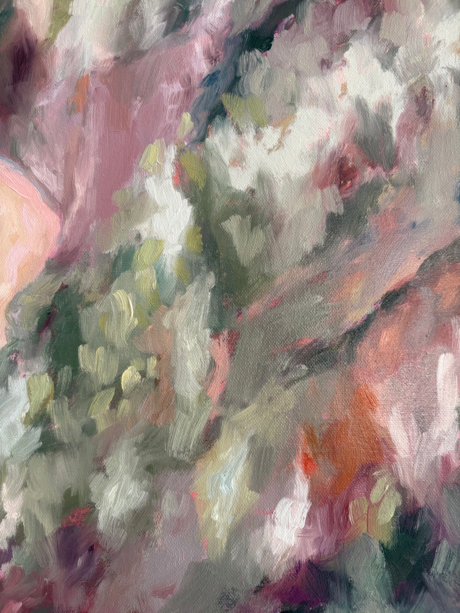 Close up of painting with a mix of pink, green, and orange colours.
