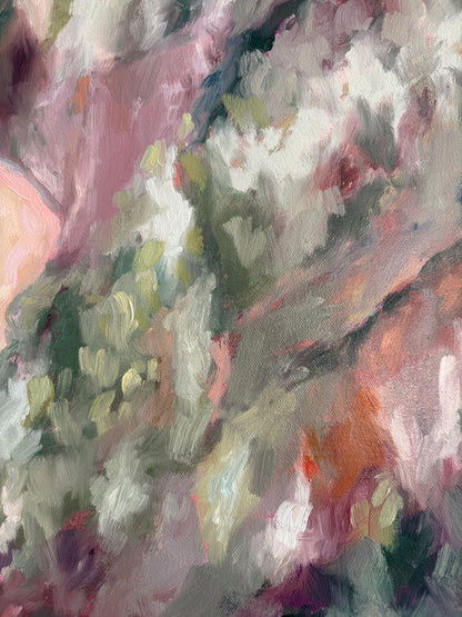 Close up of painting with a mix of pink, green, and orange colours.